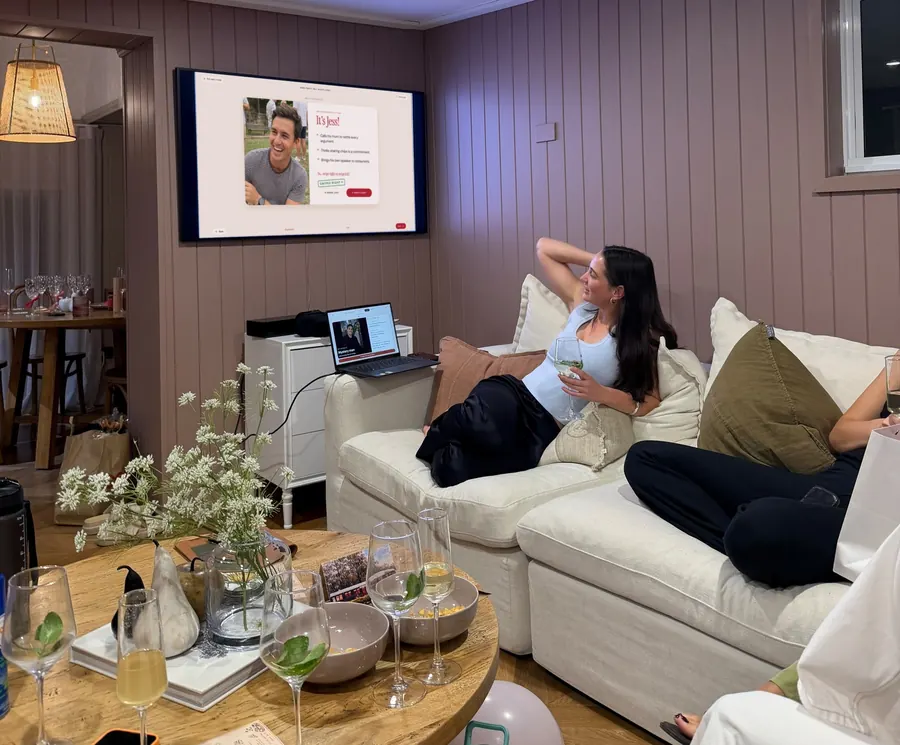 A guest watching Red Flag Roulette on the living room TV